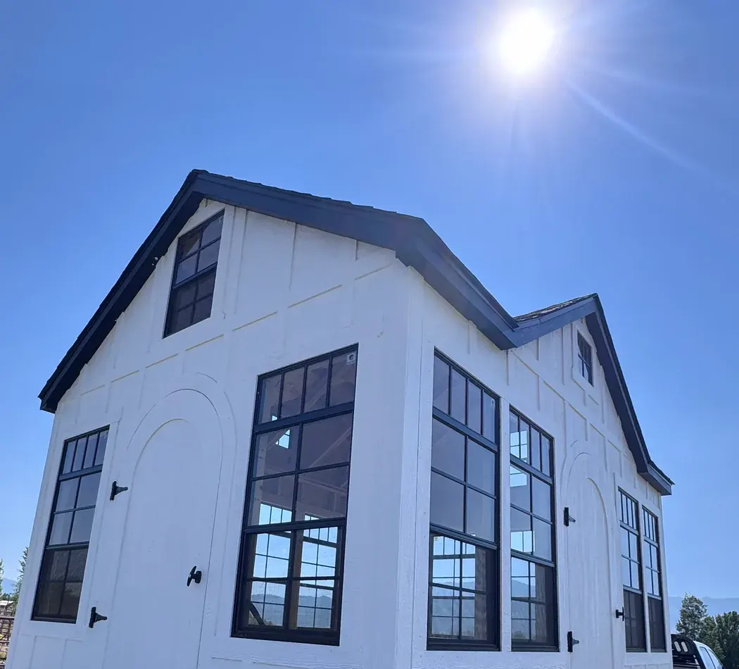 White gambrel roof shed Logan Utah