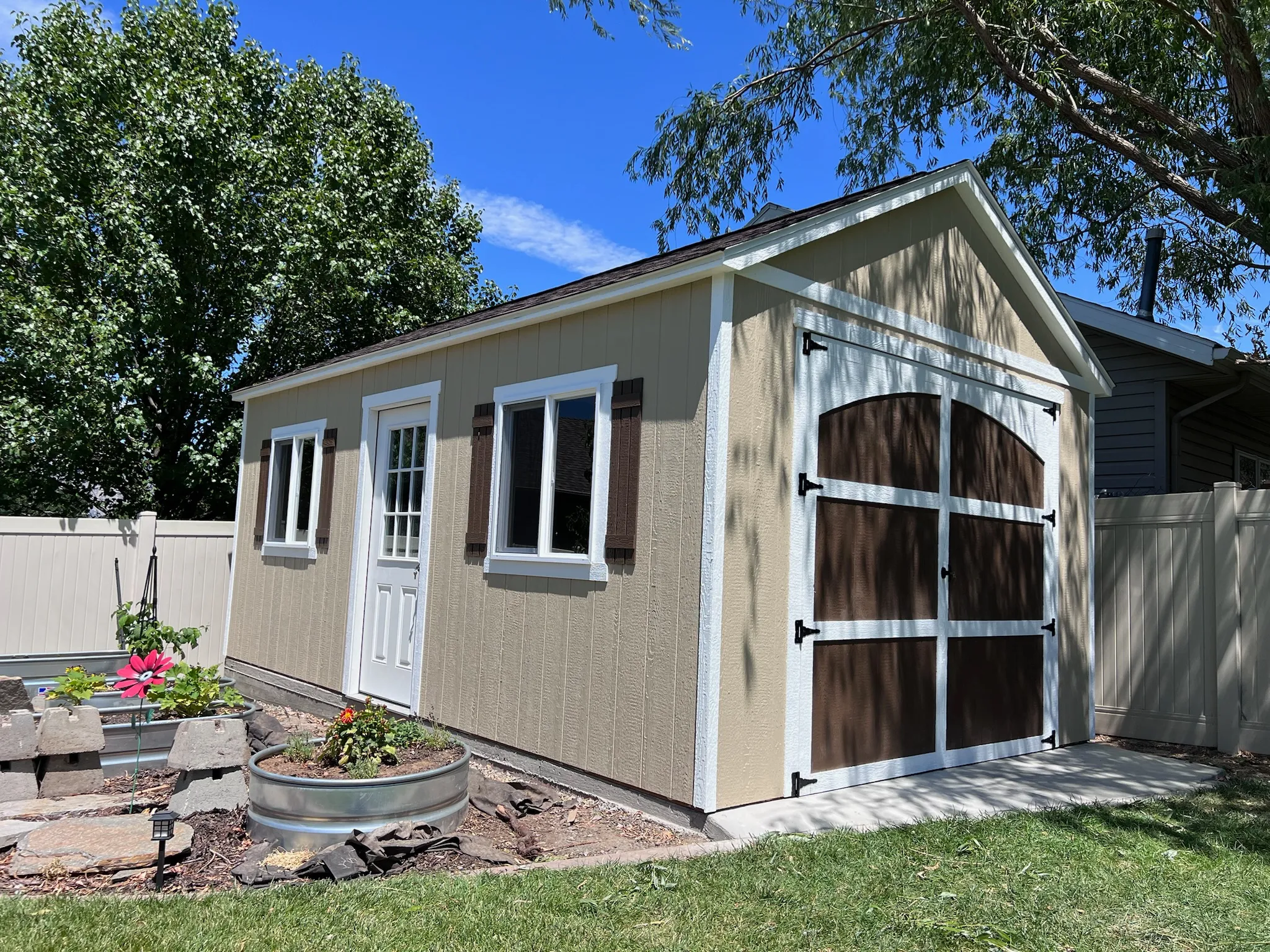 Custom shed with garden and trees built by ShedPro LLC