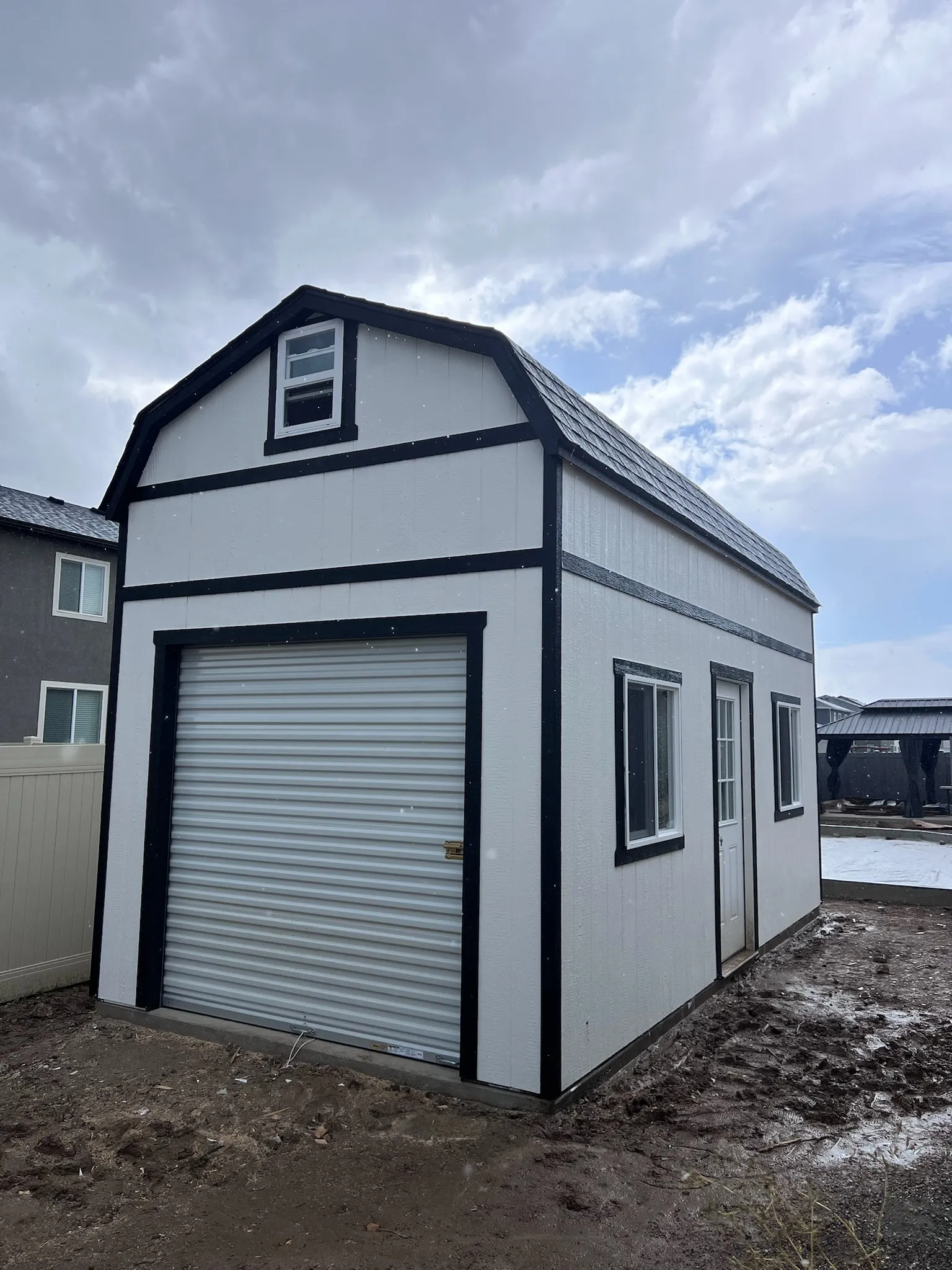 Large barn-style workshop shed with garage door built by ShedPro LLC